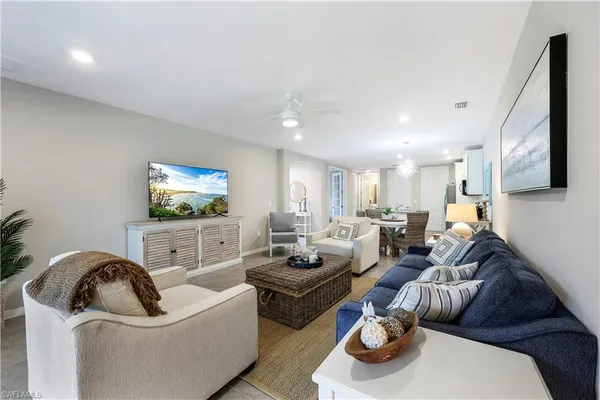 a living room with furniture and a flat screen tv