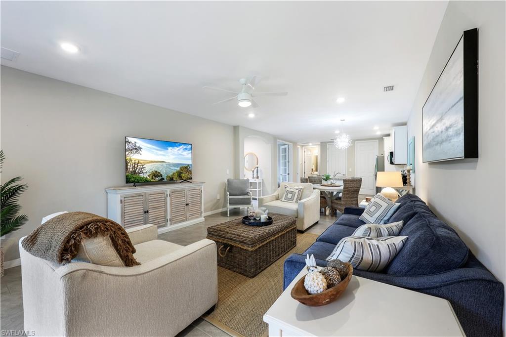 14551 Edgewater Circle Naples, FL 34114 - Photo 6 of 26 Living room with a ceiling fan, recessed lighting, and a chandelier