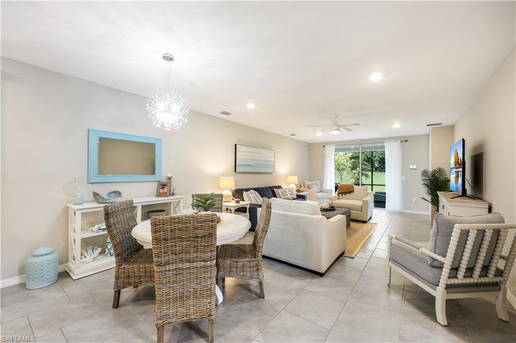 14551 Edgewater Circle Naples, FL 34114 - Photo 8 of 26 Dining space featuring light tile patterned floors, recessed lighting, ceiling fan, and a chandelier