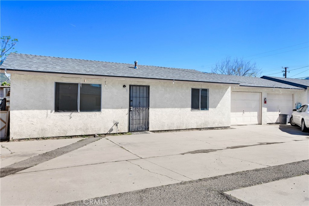 4039 Lorraine Drive, Unit 5 San Bernardino, CA 92407 - Photo 4 of 15 a white house that has a tree in front of it