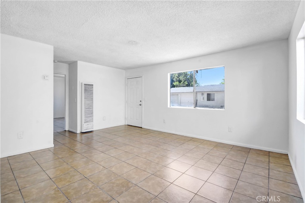 4039 Lorraine Drive, Unit 5 San Bernardino, CA 92407 - Photo 7 of 15 an empty room with windows
