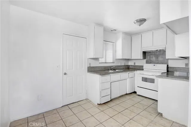 a kitchen with white cabinets