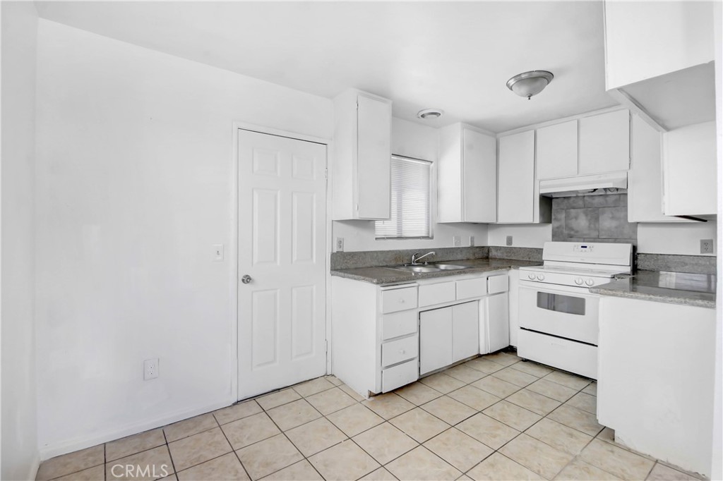 4039 Lorraine Drive, Unit 5 San Bernardino, CA 92407 - Photo 9 of 15 a kitchen with white cabinets