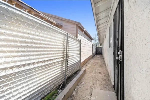 a view of a balcony with wooden floor and fence