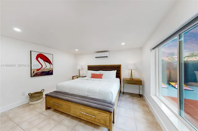 a bedroom with a bed and a painting on the wall