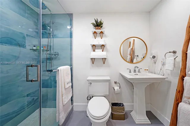 a bathroom with a toilet a sink and mirror