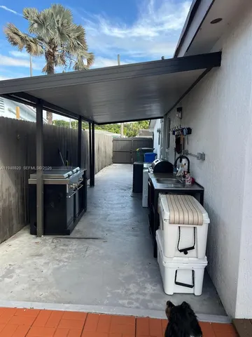 a kitchen with stainless steel appliances granite countertop a stove and a wooden cabinets