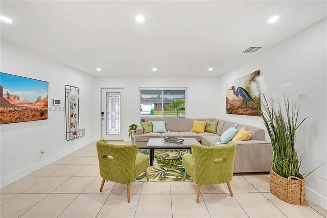 a living room with furniture and a potted plant