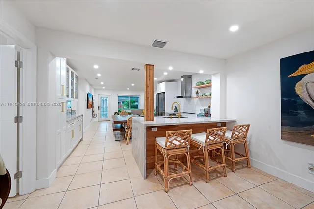 a large kitchen with a table and chairs