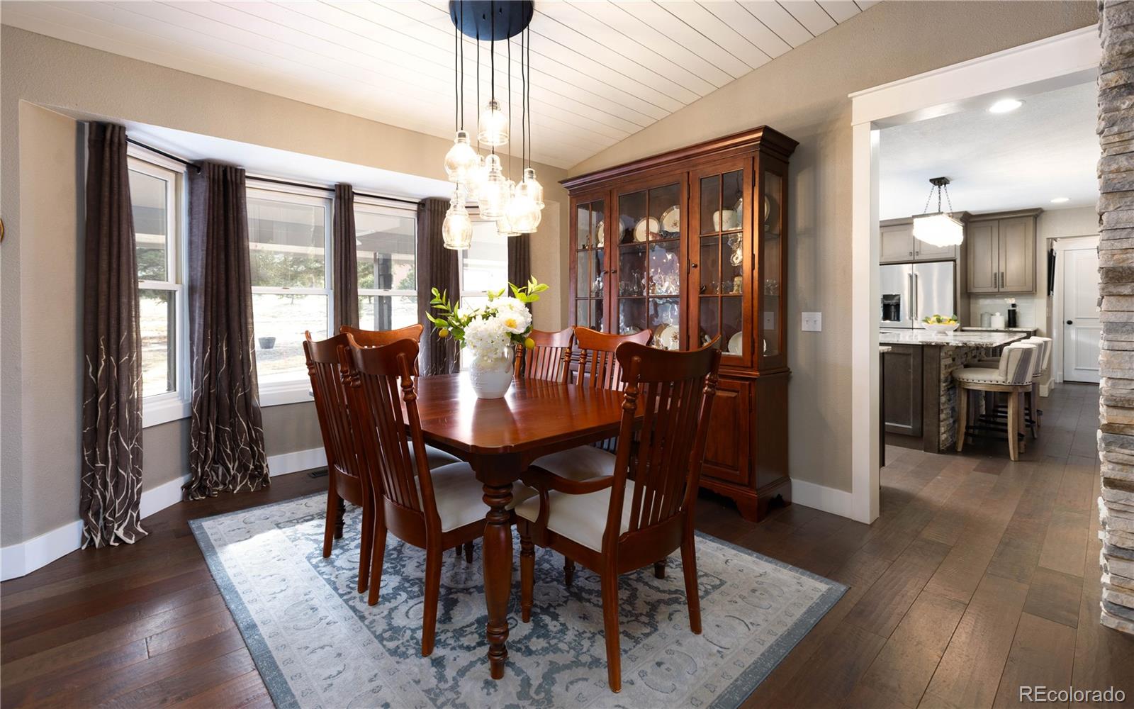 17840 New London Road Monument, CO 80132 - Photo 15 of 47 a view of a dining room with furniture wooden floor and chandelier