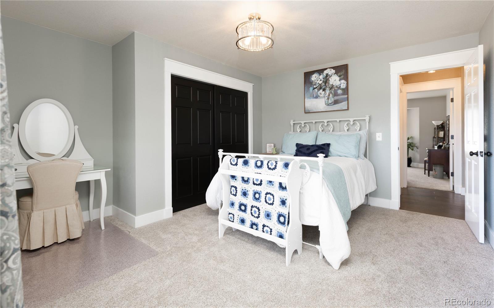 17840 New London Road Monument, CO 80132 - Photo 20 of 47 a bedroom with bed and a table