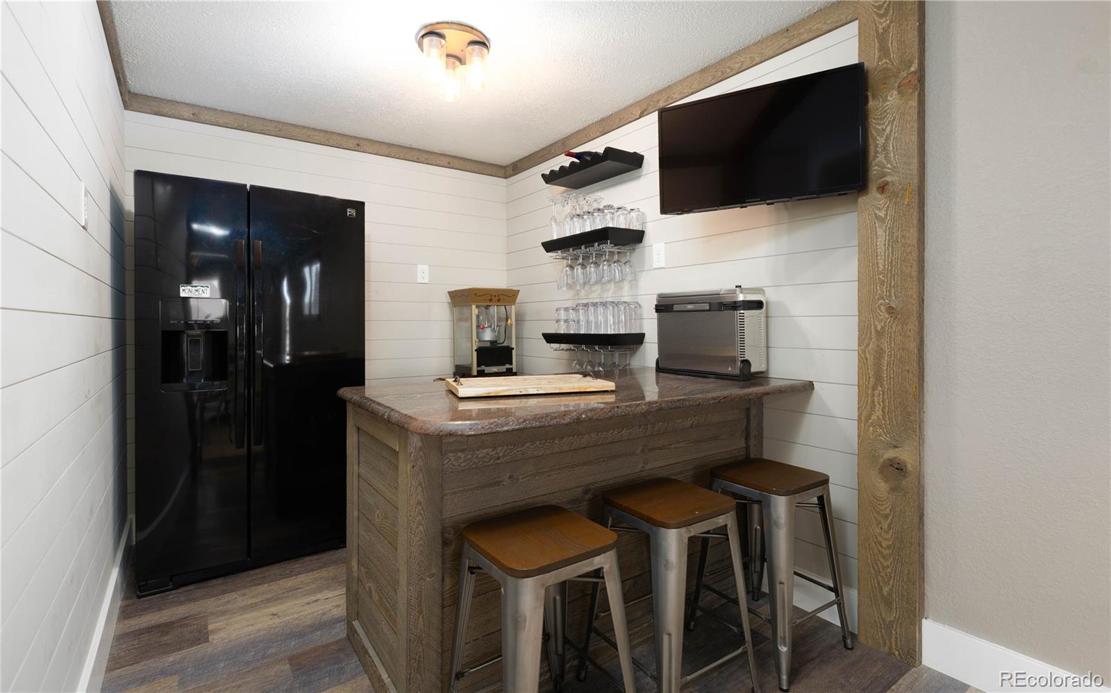 17840 New London Road Monument, CO 80132 - Photo 25 of 47 a kitchen with a table and chairs in it