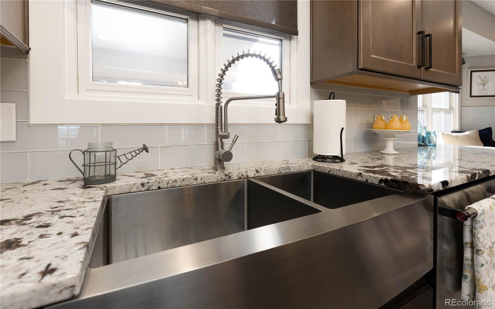 17840 New London Road Monument, CO 80132 - Photo 3 of 47 a kitchen with granite countertop a sink and a stove top oven