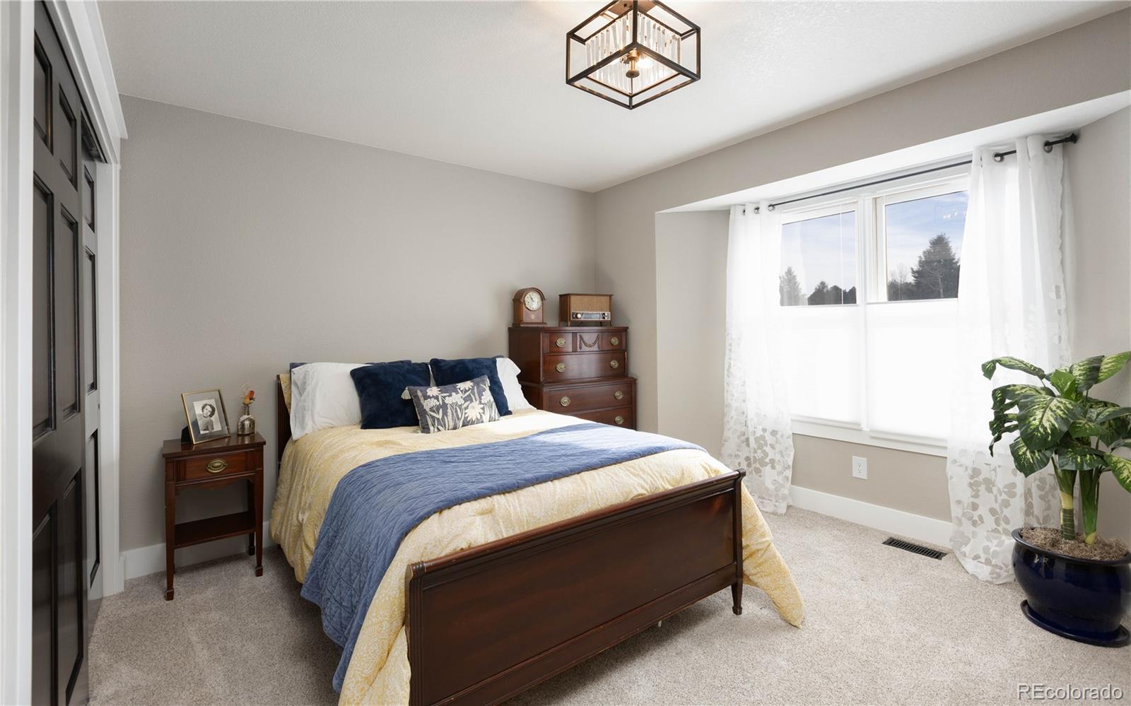 17840 New London Road Monument, CO 80132 - Photo 40 of 47 a bedroom with a large bed and a potted plant