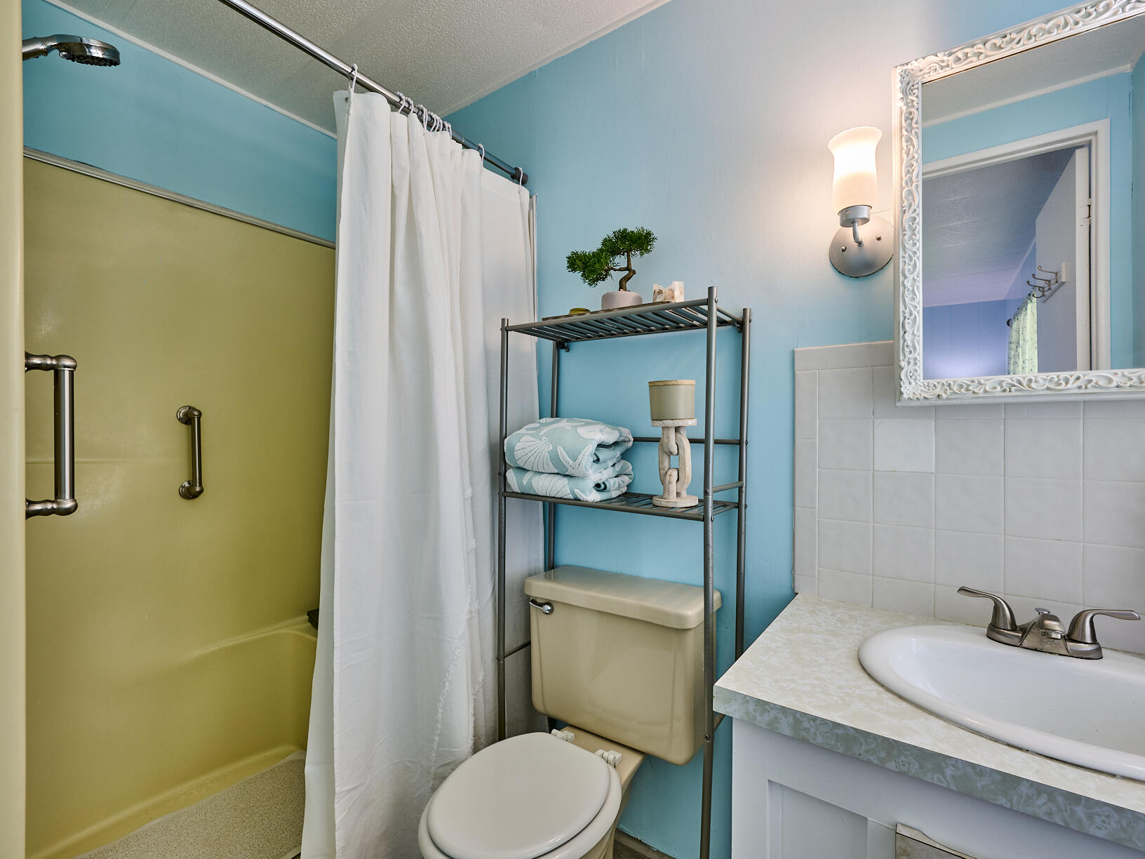 6977 Southeast Delegate Street Hobe Sound, FL 33455 - Photo 33 of 60 a bathroom with a sink toilet and mirror