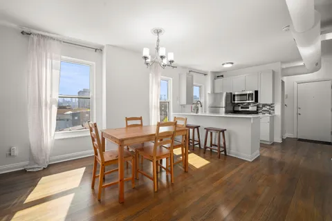 a view of a dining room with furniture and wooden floor