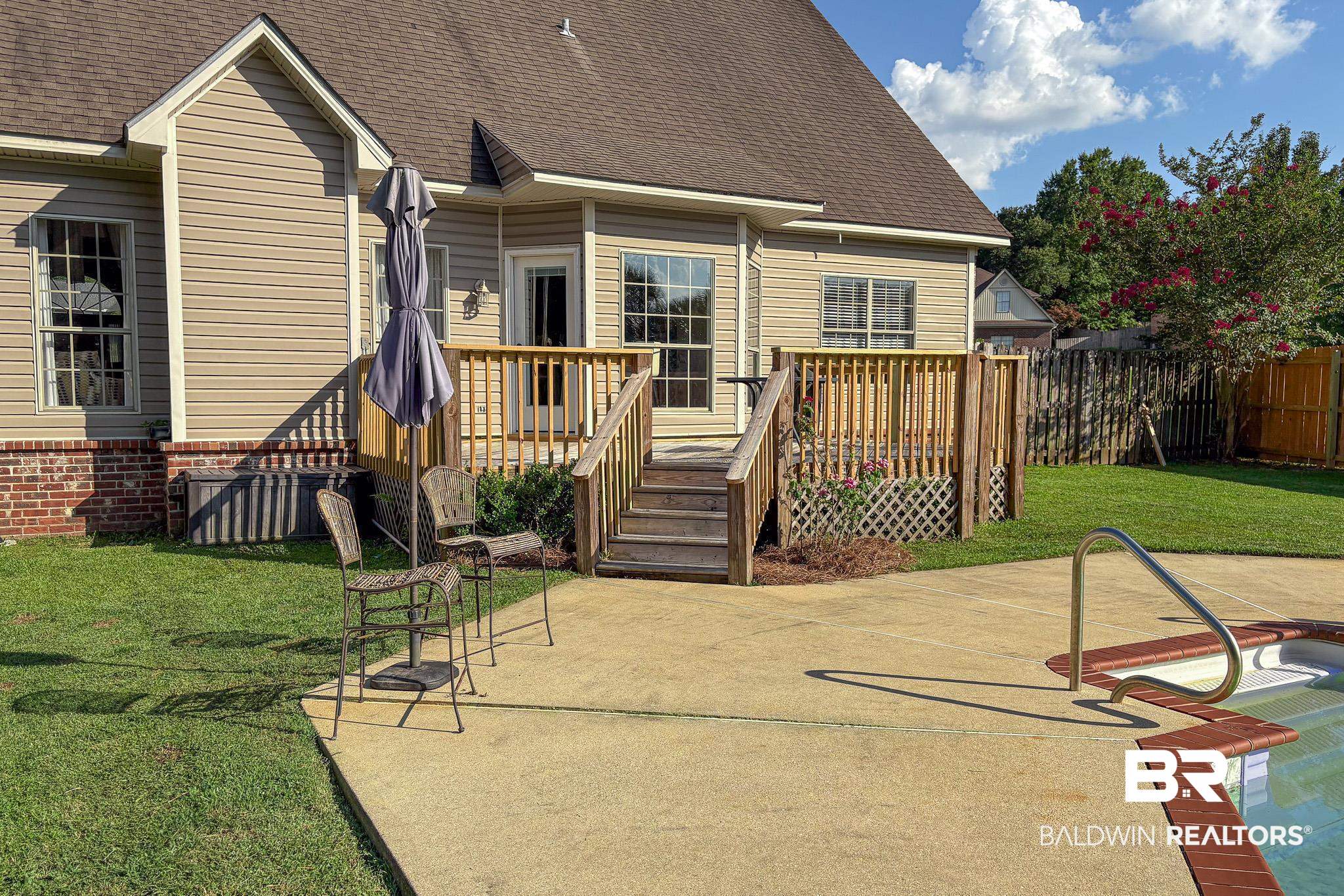 8421 Weatherford Court Daphne, AL 36527 - Photo 35 of 36 Back of house with a shingled roof, a patio area, and a wooden deck