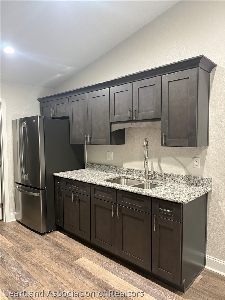 809 Redding Street Zolfo Springs, FL 33890 - Photo 6 of 8 a kitchen with a sink refrigerator and cabinets