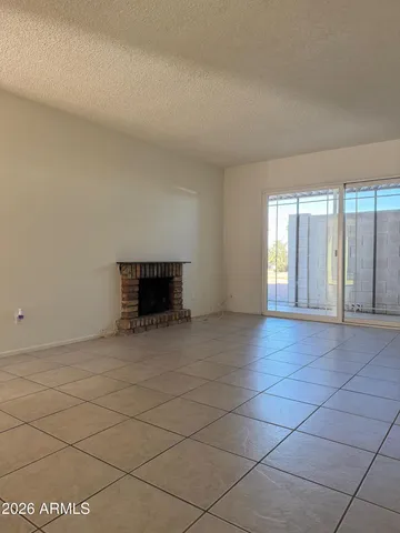 a view of empty room with a fireplace