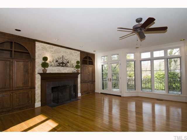 3936 Dover Road Durham, NC 27707 - Photo 8 of 12 A wall of floor to ceiling windows with transoms carry natural light from the family room to the breakfast room and kitchen. Den/Family/Great Room