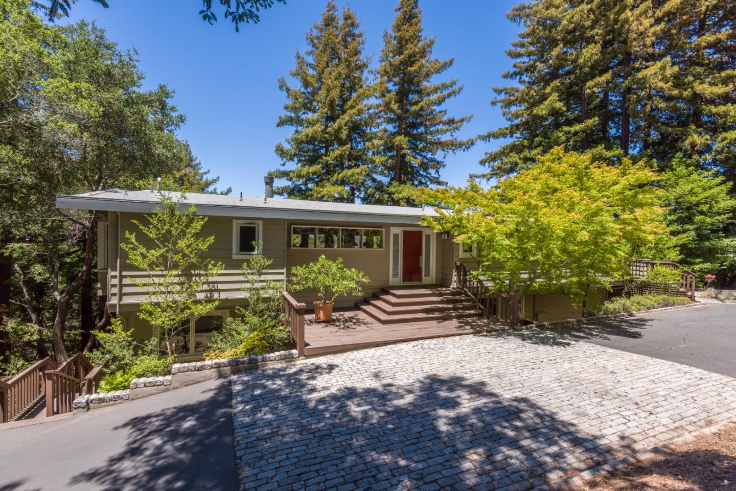 790 Patrol Road Woodside, CA 94062 - Photo 2 of 26 a front view of a house with garden
