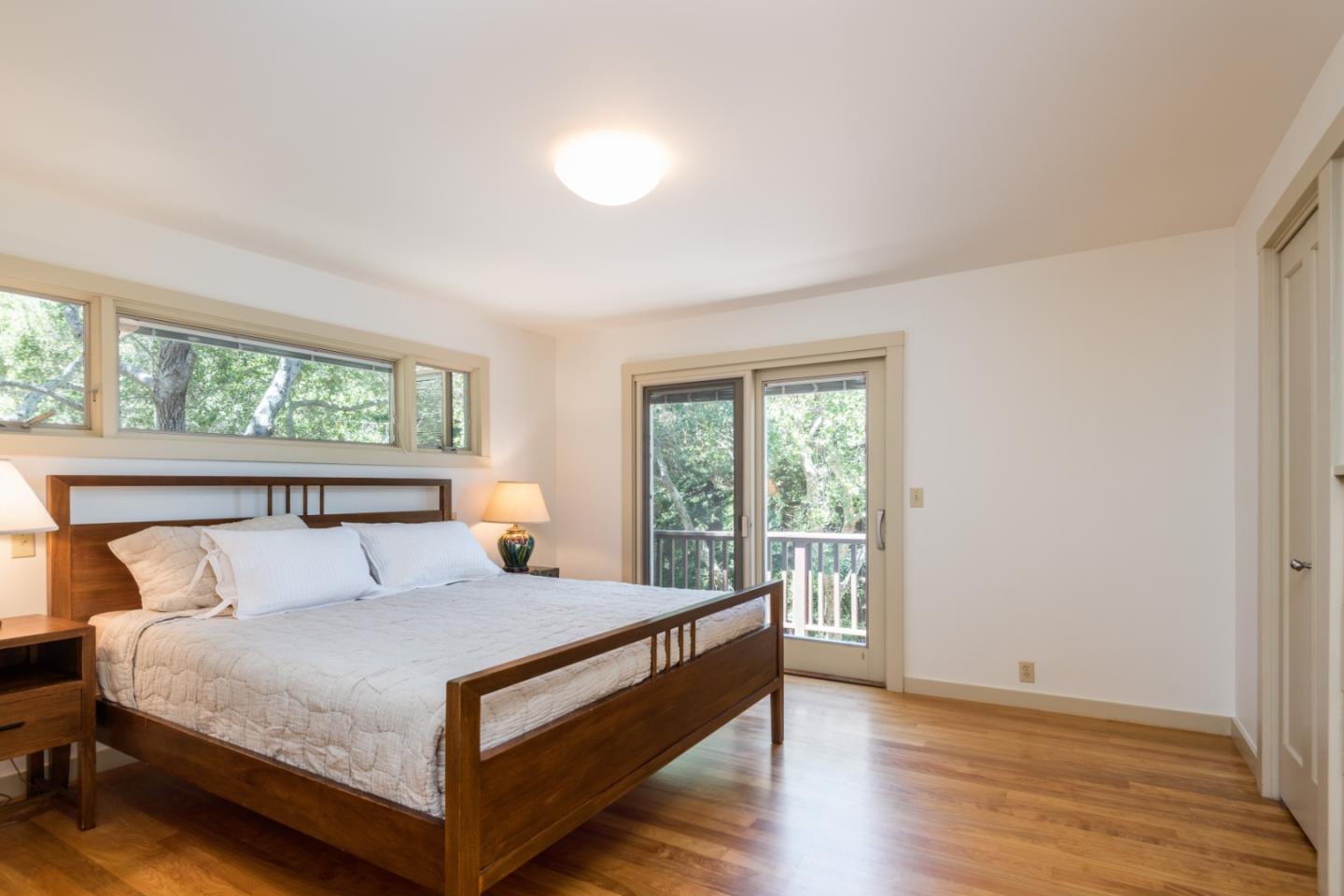 790 Patrol Road Woodside, CA 94062 - Photo 13 of 26 a large bed sitting in a bedroom next to a window