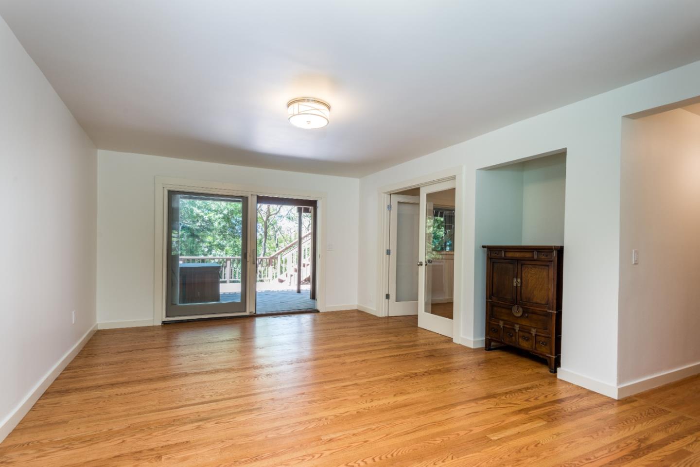 790 Patrol Road Woodside, CA 94062 - Photo 15 of 26 a view of an empty room with window and wooden floor