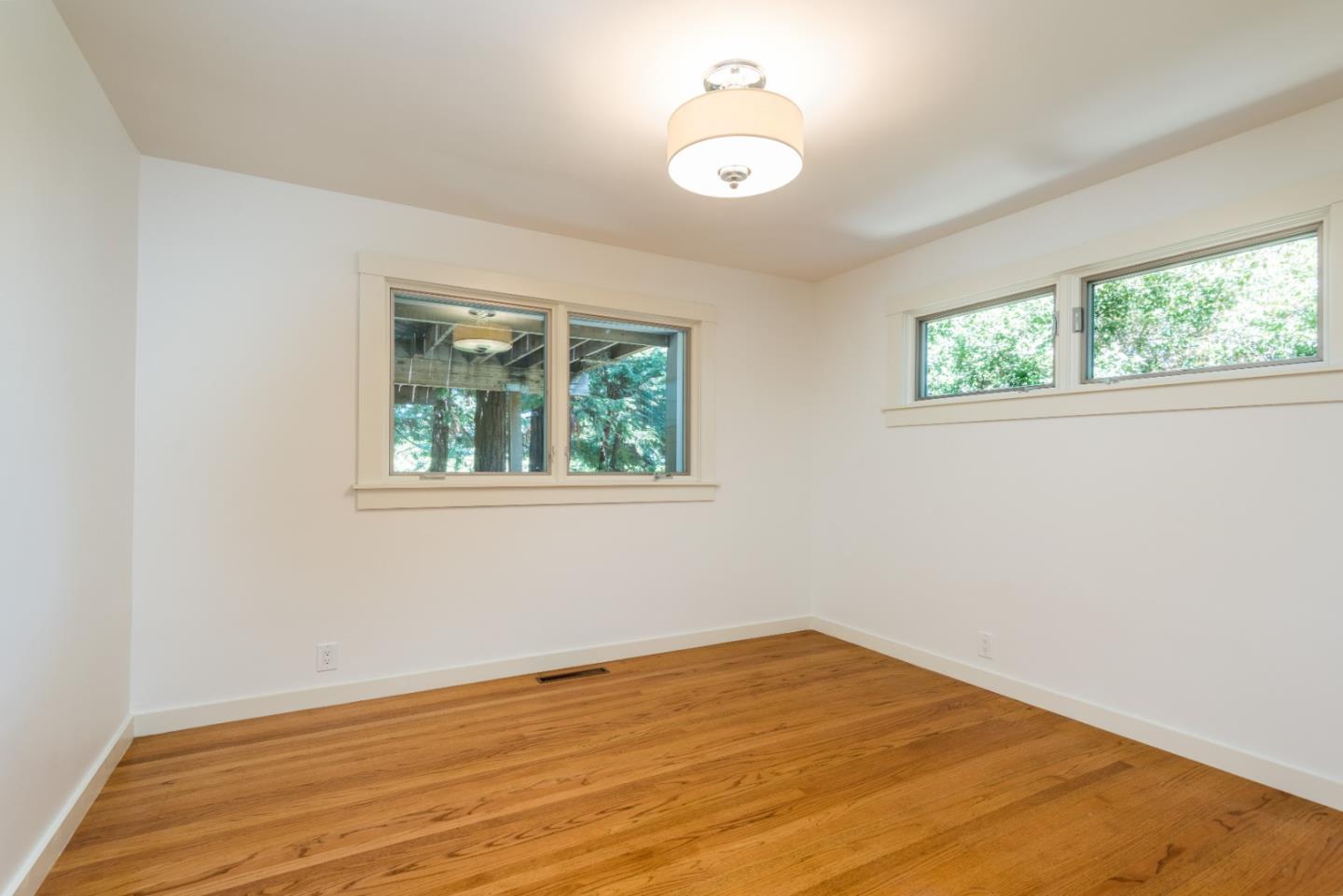 790 Patrol Road Woodside, CA 94062 - Photo 18 of 26 a view of empty room with wooden floor and fan