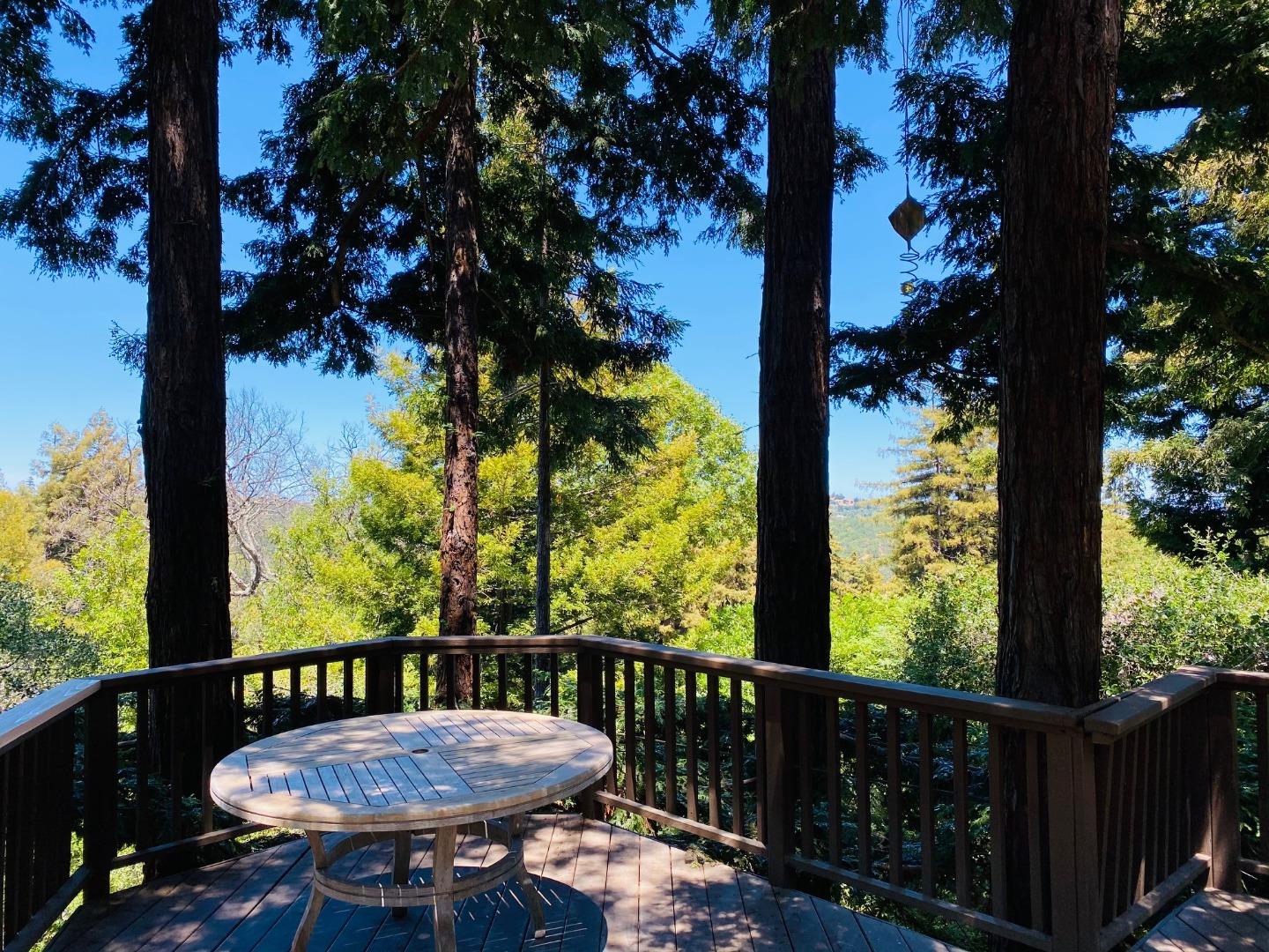 790 Patrol Road Woodside, CA 94062 - Photo 23 of 26 a view of a balcony with a table and chairs