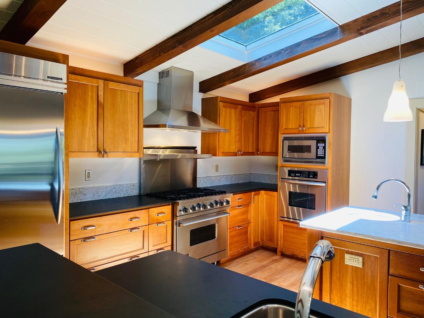 790 Patrol Road Woodside, CA 94062 - Photo 10 of 26 a kitchen with stainless steel appliances a stove a sink and a refrigerator