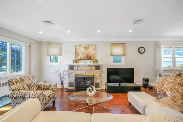 a living room with furniture a flat screen tv and a fireplace