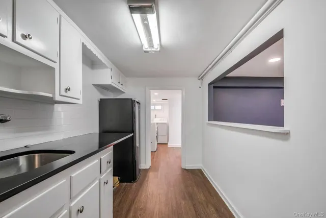 a kitchen with a refrigerator and a sink