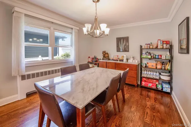 a dining room with furniture a window and wooden floor