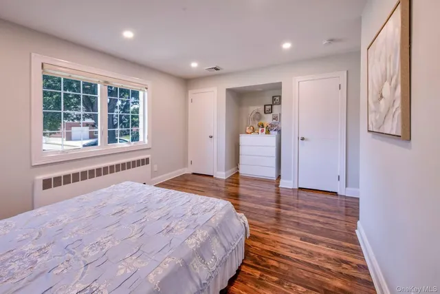 a bedroom with a bed and a large window