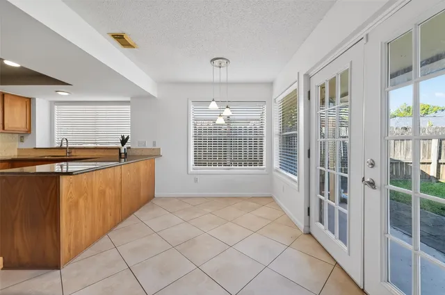 a kitchen with stainless steel appliances granite countertop a sink and a refrigerator