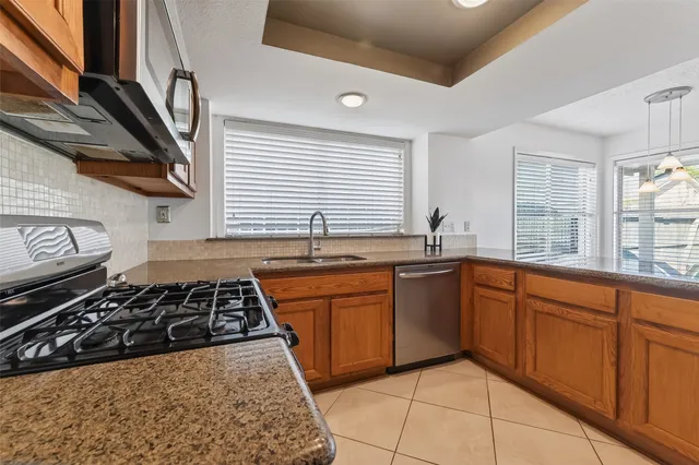 a kitchen with stainless steel appliances granite countertop a stove and a sink