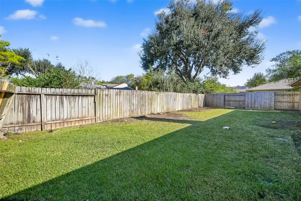 a view of a backyard with a garden and tree
