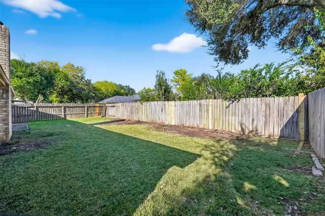 a view of a backyard with a garden and entertaining space