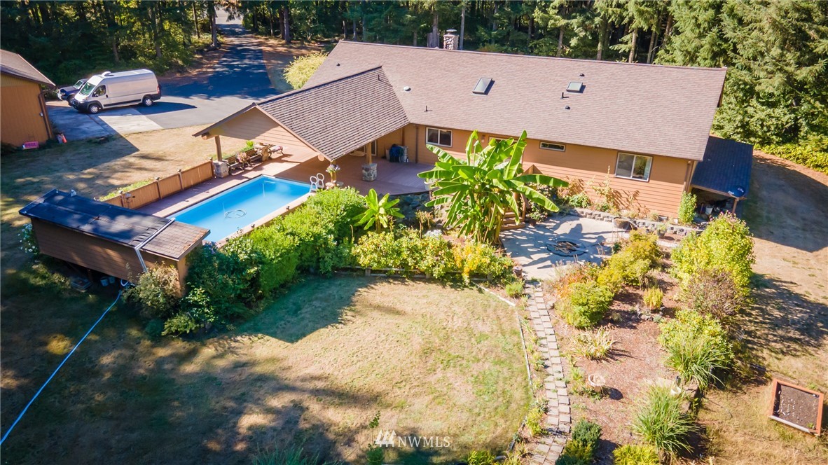249 Coma Road Winlock, WA 98596 - Photo 5 of 38 an aerial view of a house with a yard pool a fire pit and outdoor seating