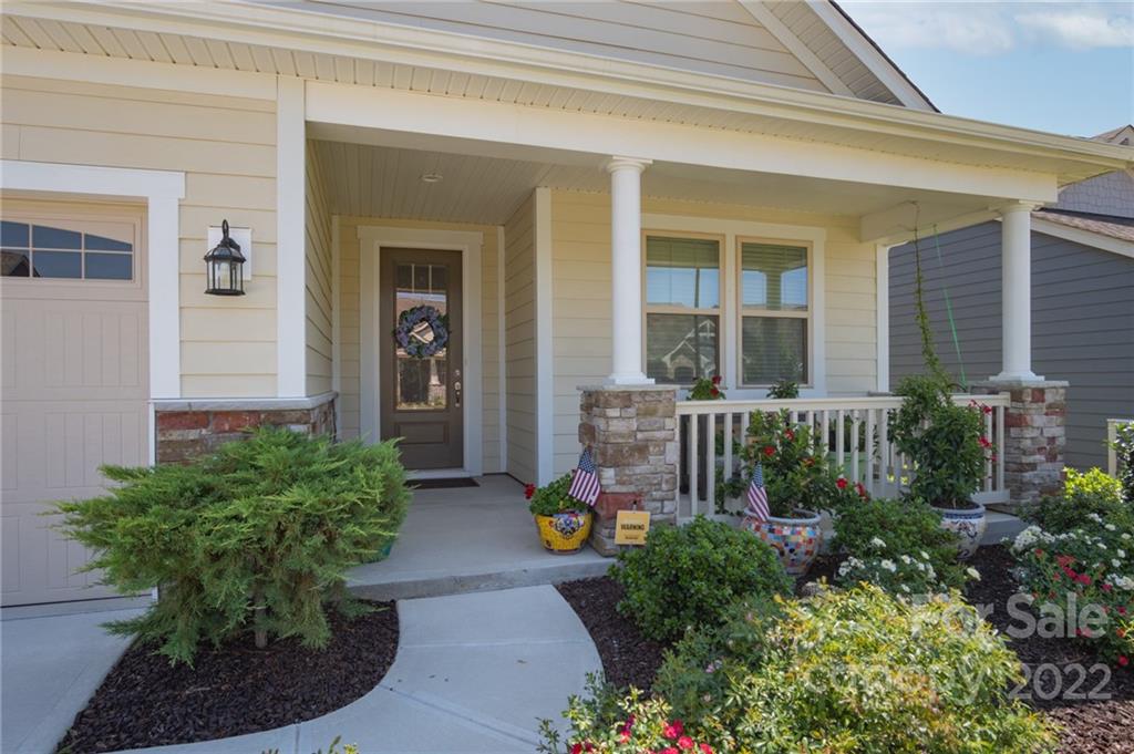 a house with beautiful flower in front of house