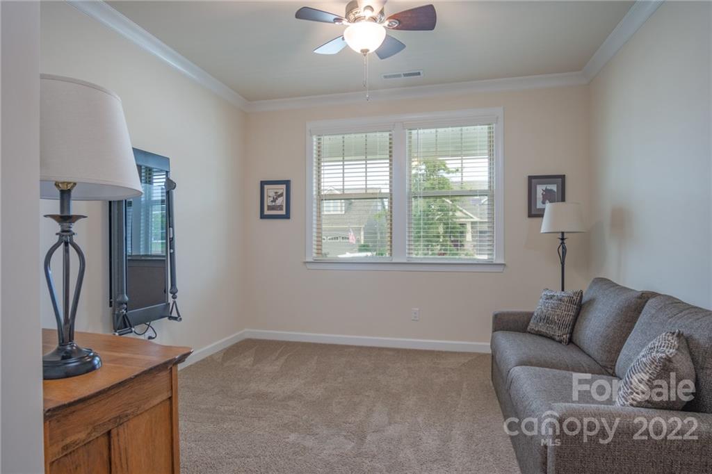1213 Independence Street Tega Cay, SC 29708 - Photo 17 of 35 a living room with furniture a flat screen tv and a window