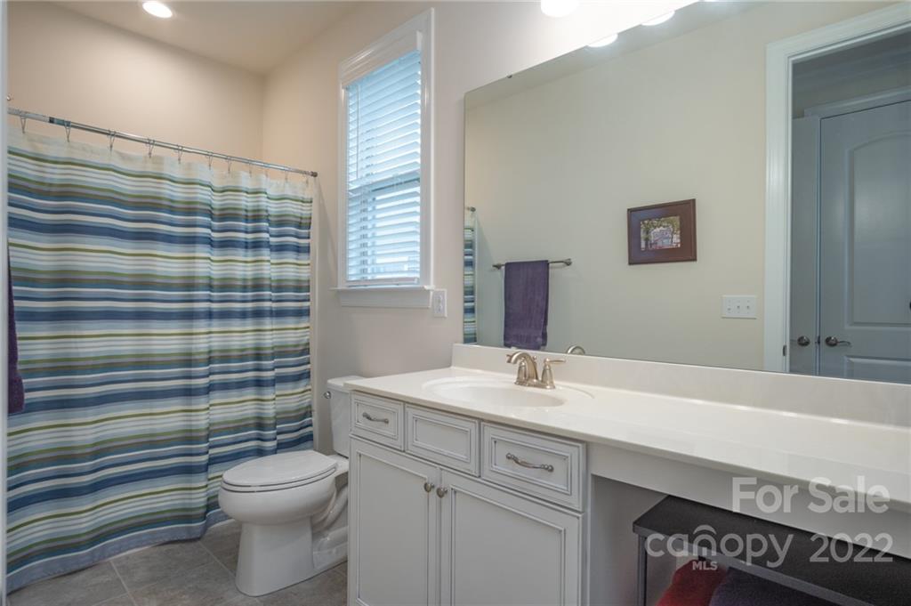 1213 Independence Street Tega Cay, SC 29708 - Photo 18 of 35 a bathroom with a sink a toilet and shower
