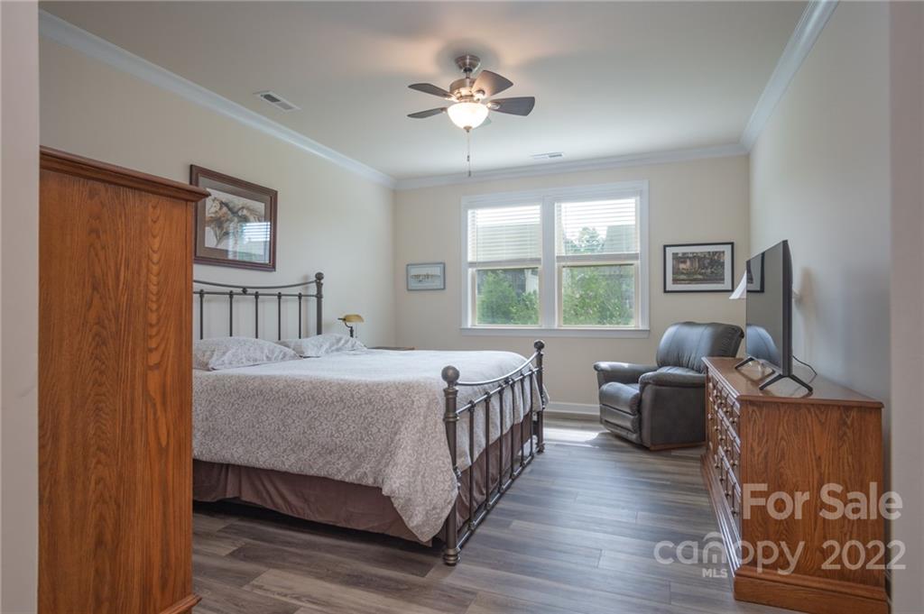 1213 Independence Street Tega Cay, SC 29708 - Photo 19 of 35 a bedroom with a bed couch and a window