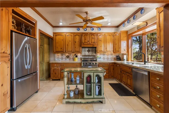 a spacious bedroom with a bed and a chandelier