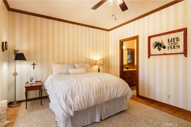 a bedroom with a large bed and a chandelier