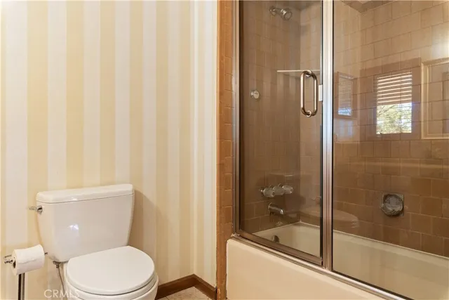 a view of a roof deck with table and chairs under an umbrella