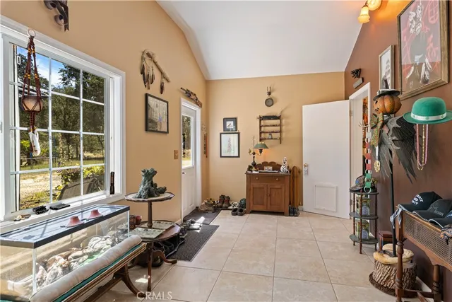 a view of a small house with a large window and wooden fence