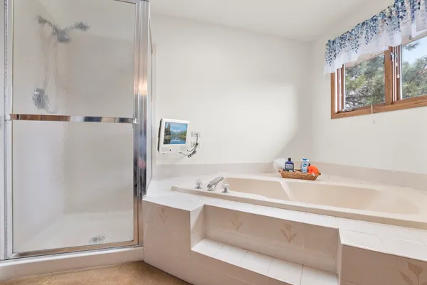 a spacious bathroom with a bathtub and a shower