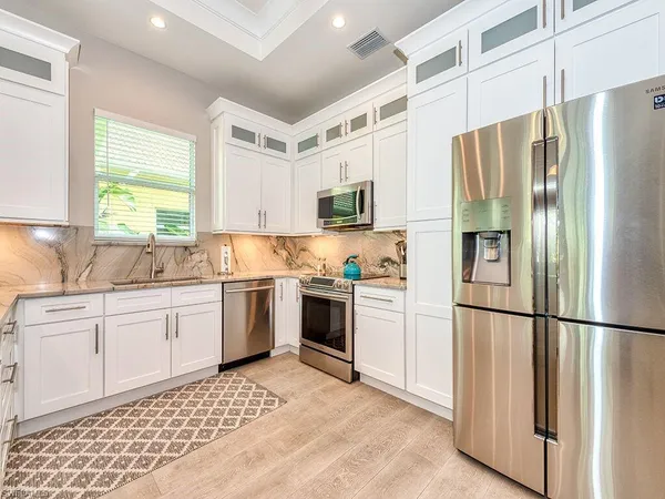 a kitchen with a refrigerator stove and sink
