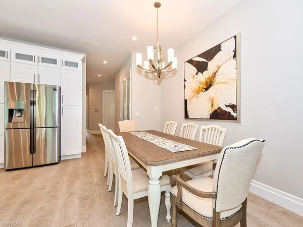 a view of a dining room with furniture and a chandelier